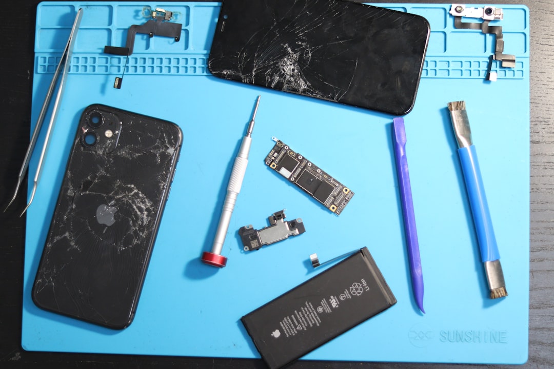 Phone parts scattered on a repair mat.